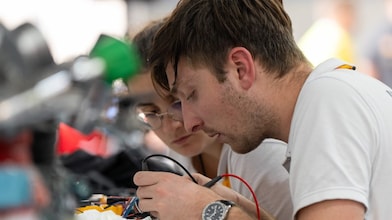 Two people working on a device