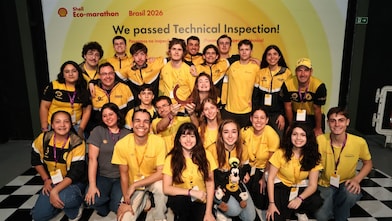 Shell Eco-marathon Brazil 2026 team in yellow uniforms posing after passing technical inspection.