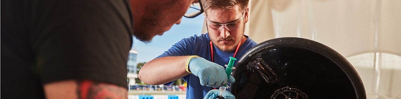 Engineers work on car