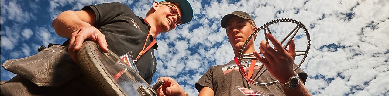 Two engineers hold wheel parts