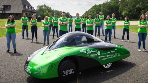 Team standing around car