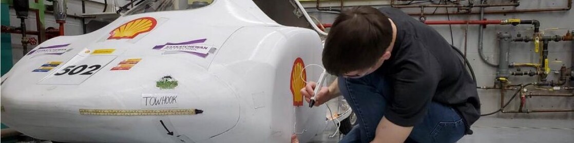 Student working on car