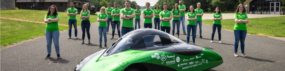 Team standing around car