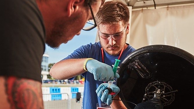 Engineers work on car