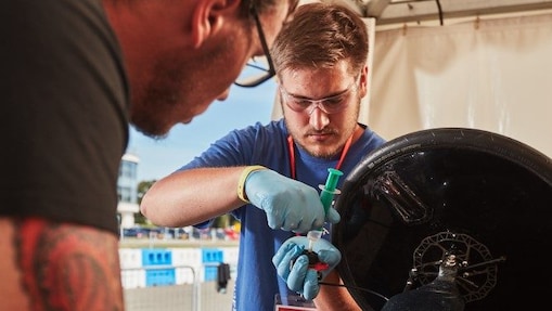 Engineers work on car