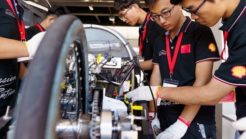 Students gather around vehicle