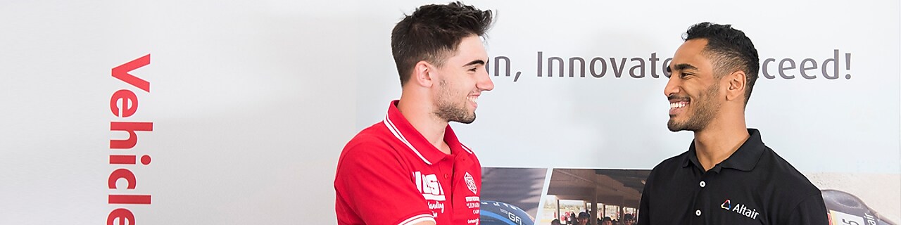 Altair represenatives shaking hands with students