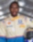 A person in a race car suit holding a helmet