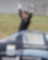 A person celebrating near a race car
