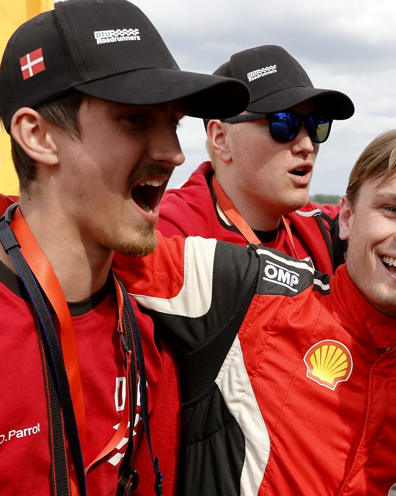 A group of men in red uniforms, celebrating