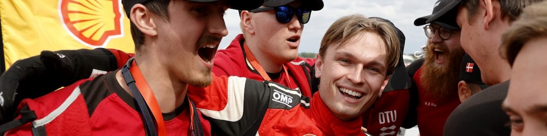 A group of men in red uniforms, celebrating