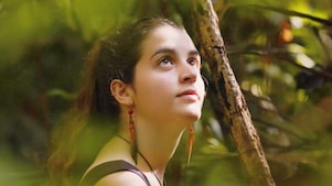 A person in the forest looking up
