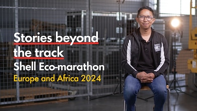  A young person with glasses, having a chat in the racetrack paddock