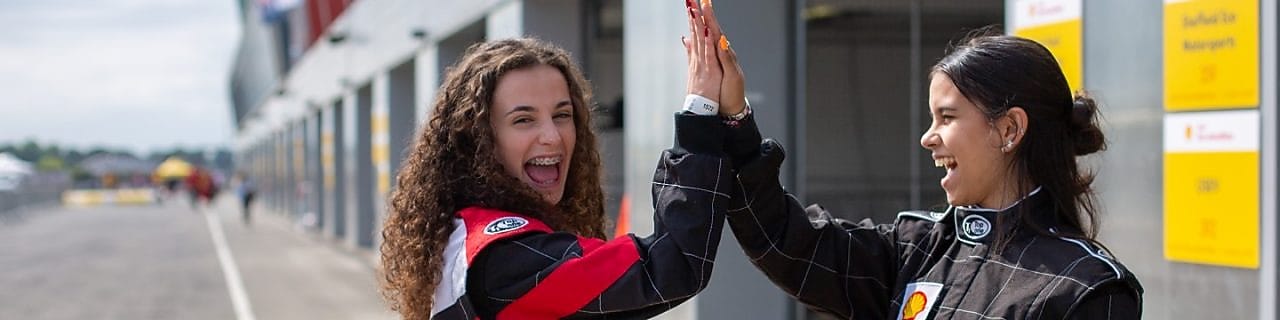 Shell Eco-marathon teams and cars stand together on track