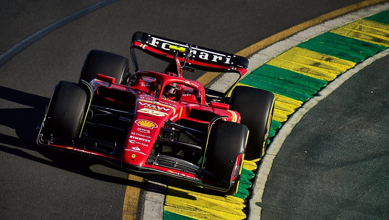 Red and black Ferrari F1 race car driving on track