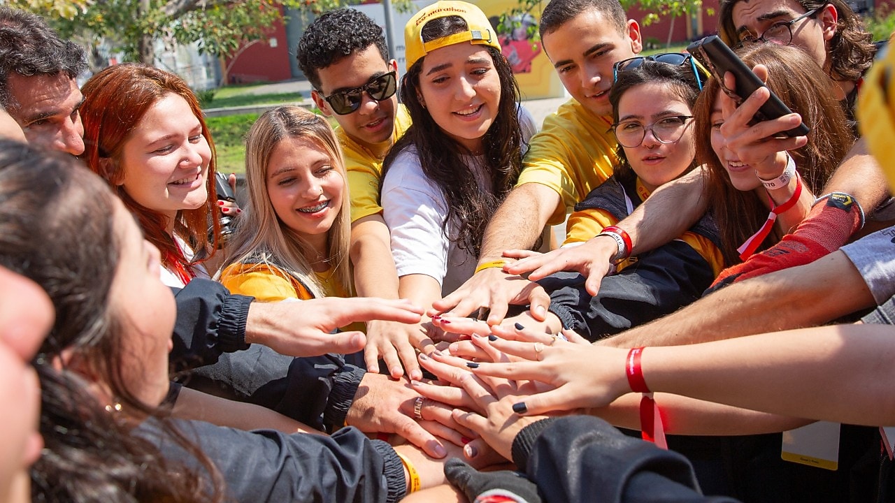 A group of people with their hands on top of each other