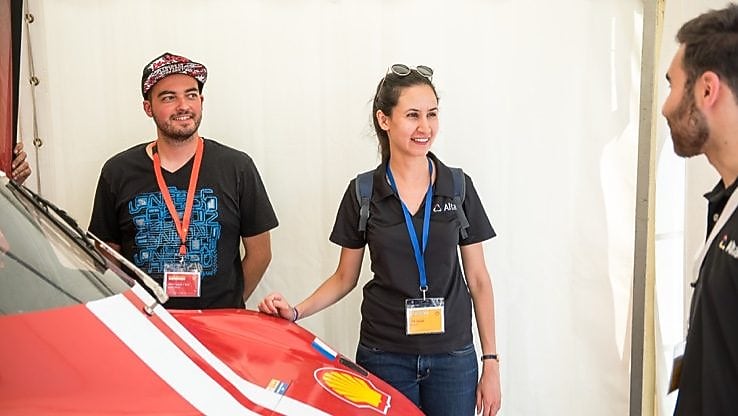 Shell Eco-marathon team stand around red car