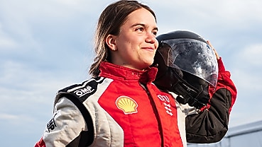 DTU driver poses with helmet on her shoulder