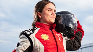 DTU driver poses with helmet on her shoulder