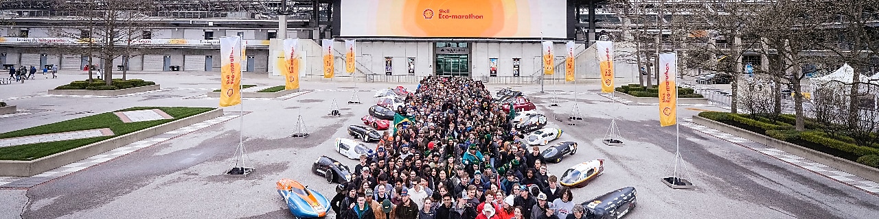 A group of people and prototype vehicles standing together at an engineering competition