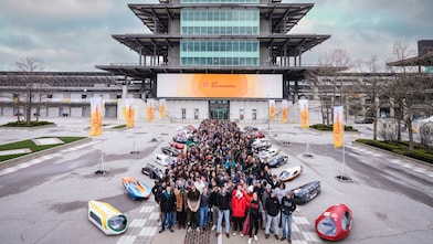 A group of people and prototype vehicles standing together at an engineering competition