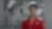 A person in red uniform inside a race paddock