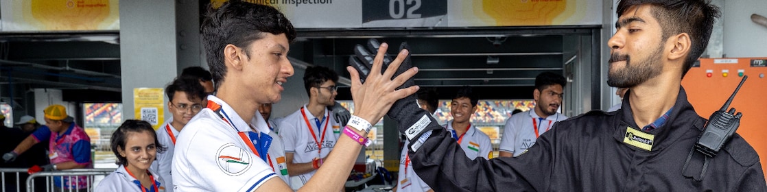 Two persons exchanging high fives.