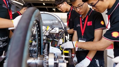 Students gather around vehicle