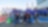 A group of young people posing in front of prototype cars on the track