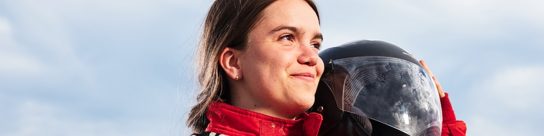 DTU driver poses with helmet on her shoulder