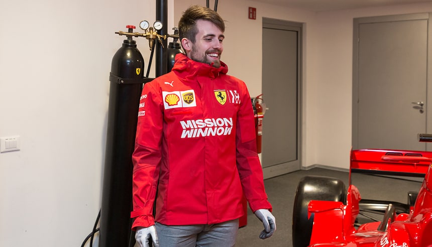 DTU team member next to a Ferrari F1 car