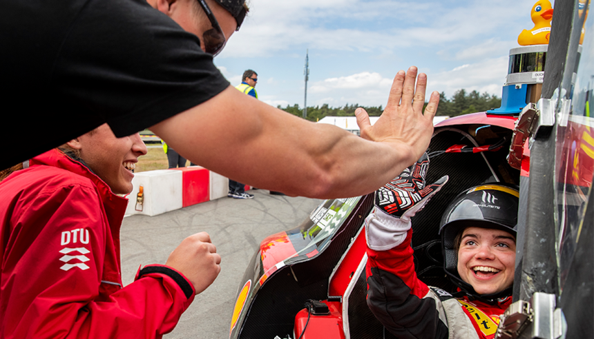 Driver gives team member a high-five