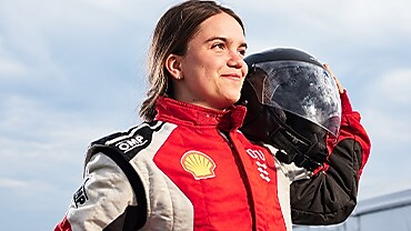 DTU driver poses with helmet on her shoulder