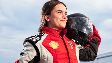DTU driver poses with helmet on her shoulder