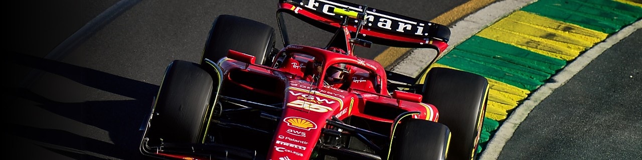 Red and black Ferrari F1 race car driving on track