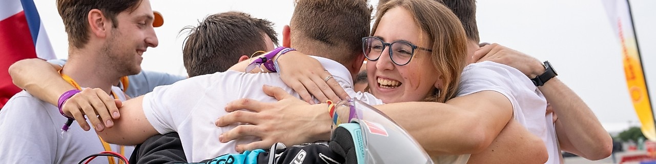 A group of students smiling, hugging and celebrating