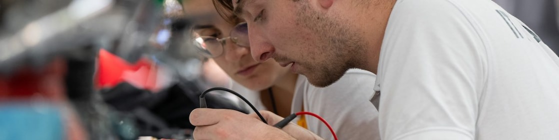 Two people working on a device
