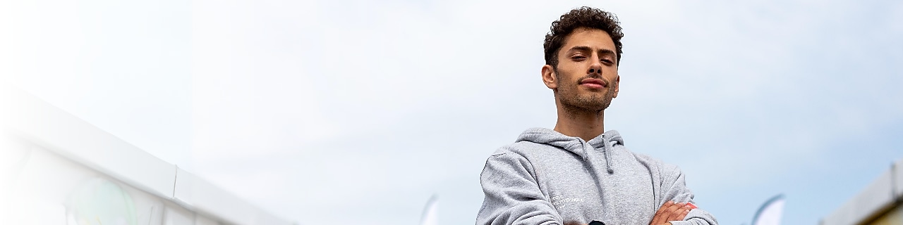 A person standing with his arms crossed